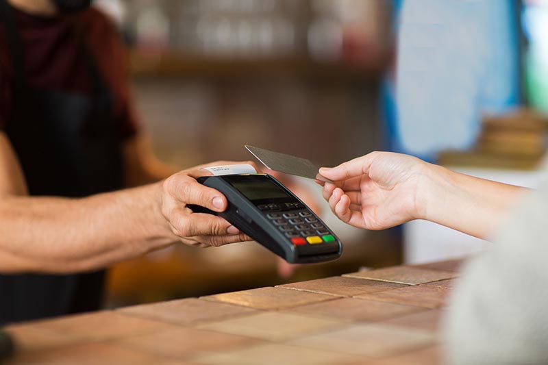 Customer paying on a wireless payment terminal. 