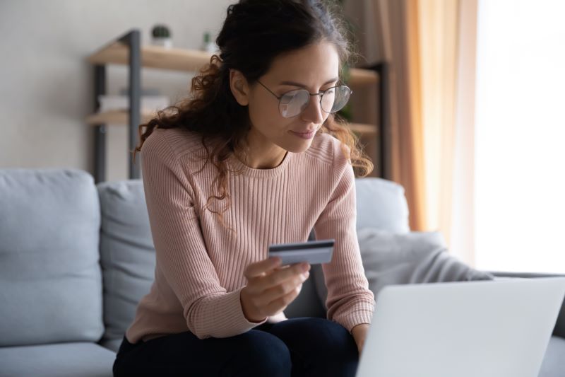 Woman using laptop for payment