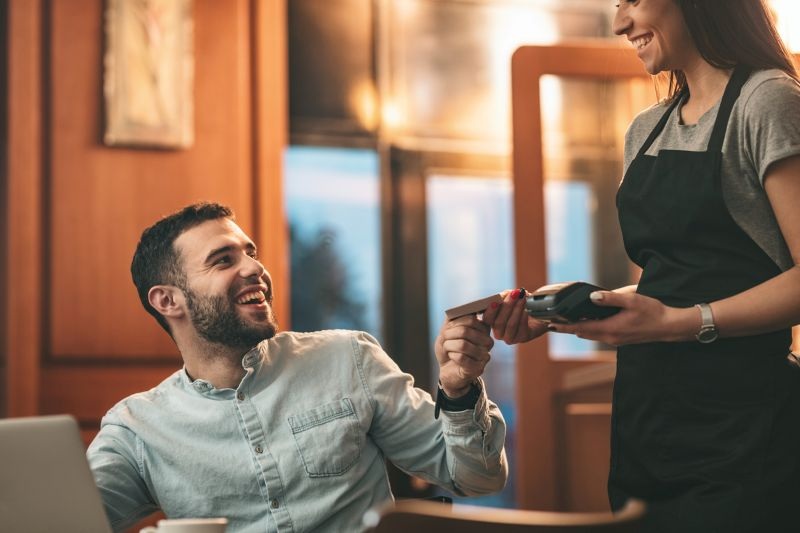 Man paying at the table with credit card