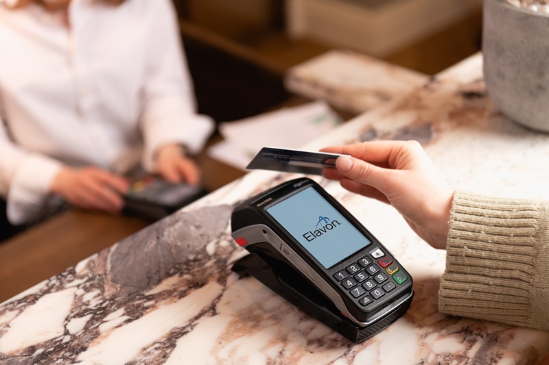 Person paying with tap to pay with card on terminal