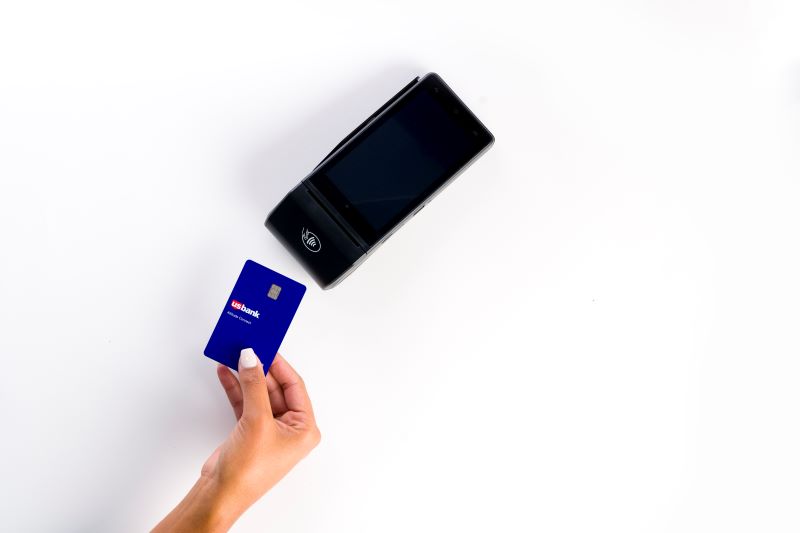 credit card near payment terminal for a touch and pay CC purchase