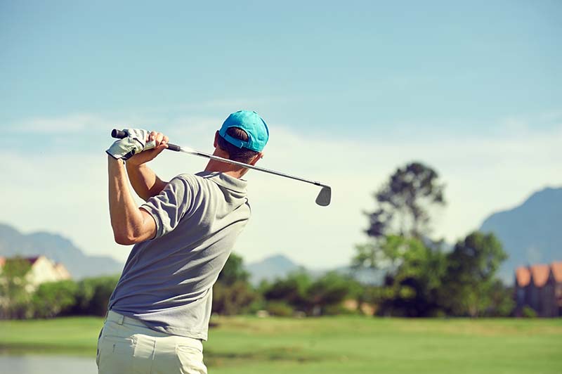 Golfer on with a follow through stance. 