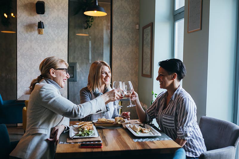 Group of women having lunch at a restaurant. 