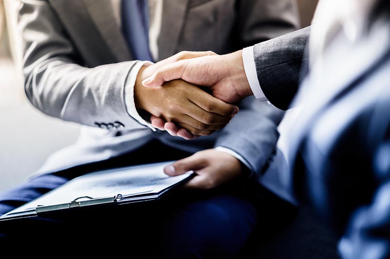 Two business people shaking hands in partnership.