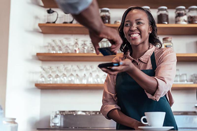 Cafe business owner accepting payments. 