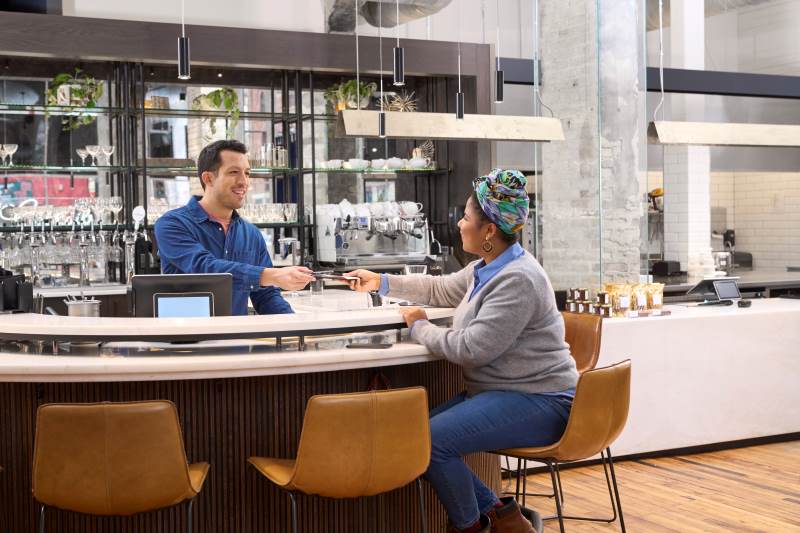 Restaurant owner taking a credit card payment