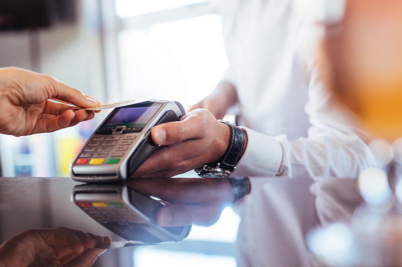 Contactless payment being processed on card reader.