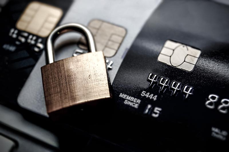 Padlock on top of 3 credit cards. 